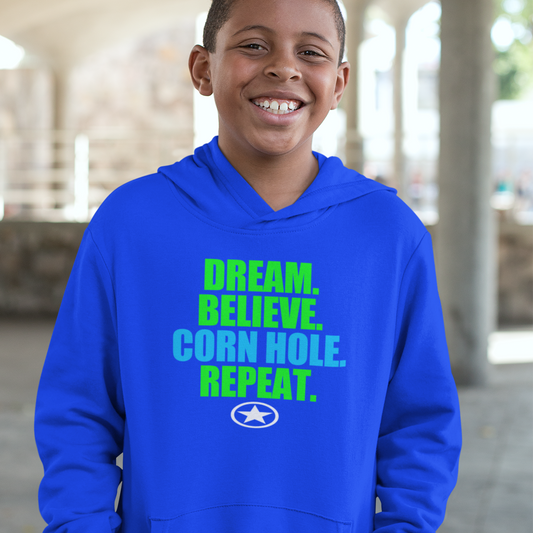 Dream. Believe. CORN HOLE. Repeat. Youth Heavy Blend Hooded Sweatshirt